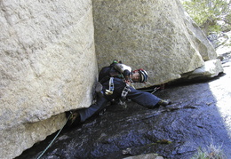 Karl climbing across some wet stuff