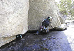 Karl climbing across some wet stuff